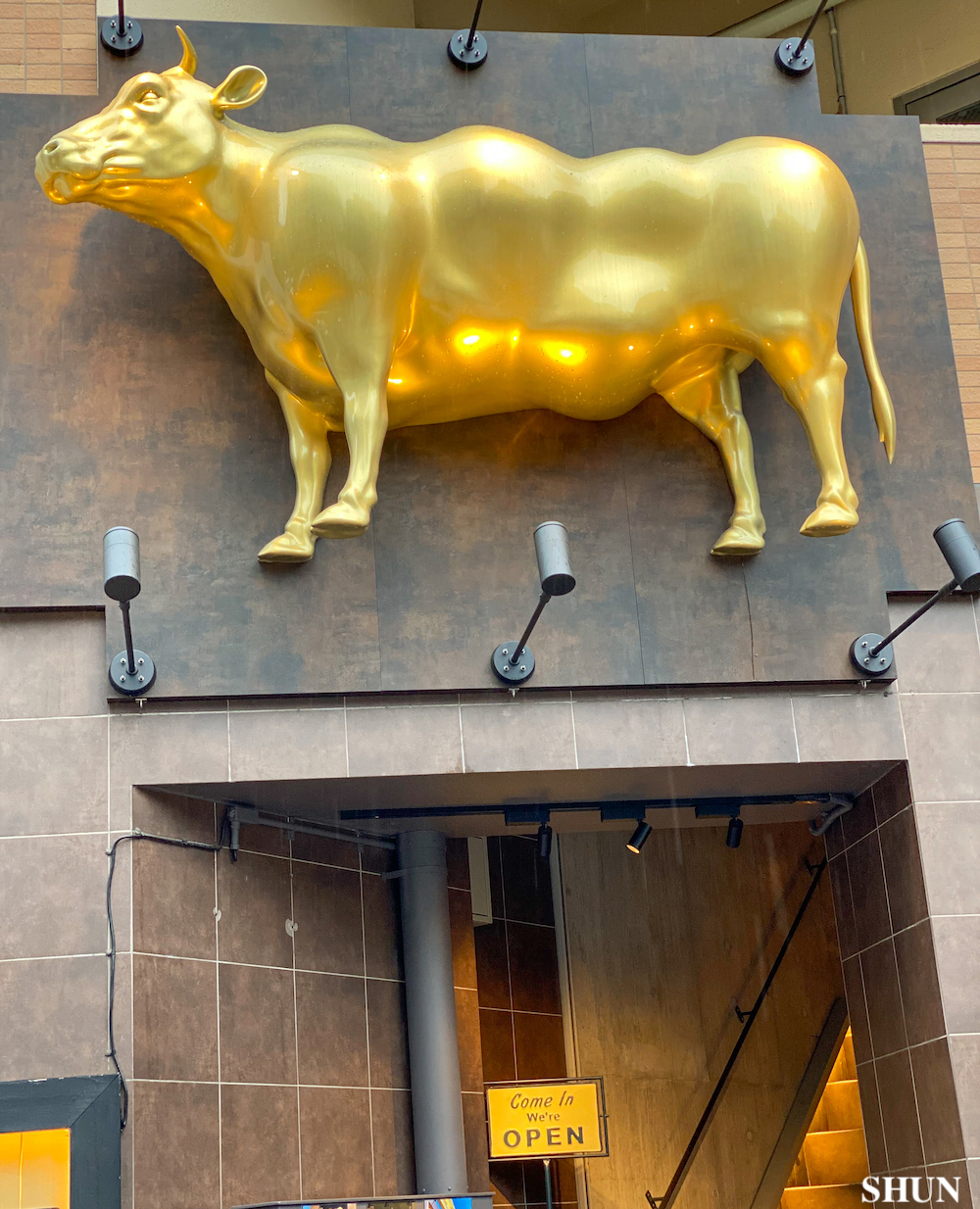 焼肉うしやま 西新宿本店のシンボル・金色の牛のオブジェ／2022年7月16日、東京都新宿／撮影：SHUN ROCKETDIVE