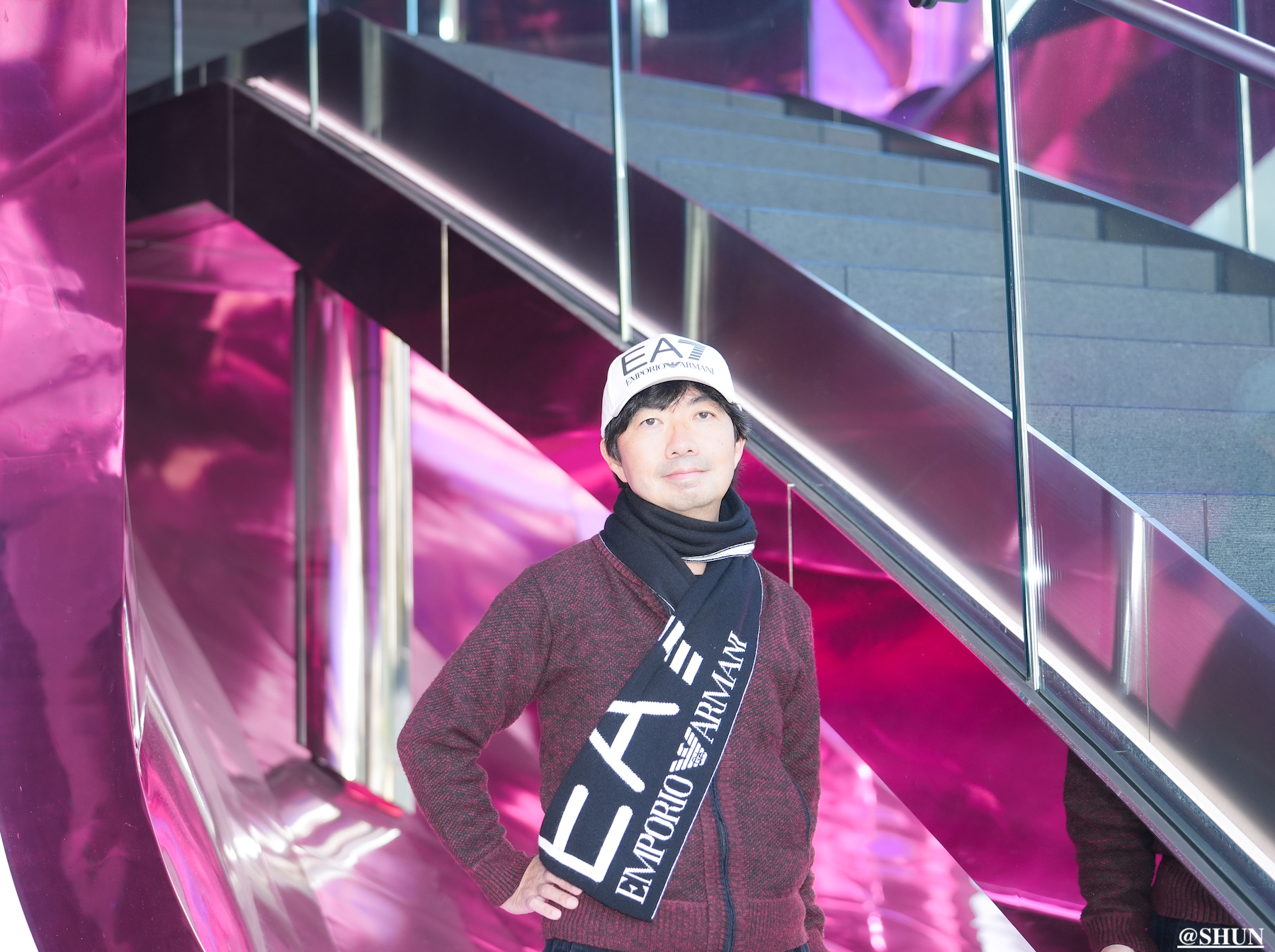 SHUN（樺澤俊悟）／渋谷桜丘のShibuya Sakura Stage「しぶS」前にて。EMPORIO ARMANI（エンポリオ アルマーニ）のマフラーと帽子着用。2023年12月3日